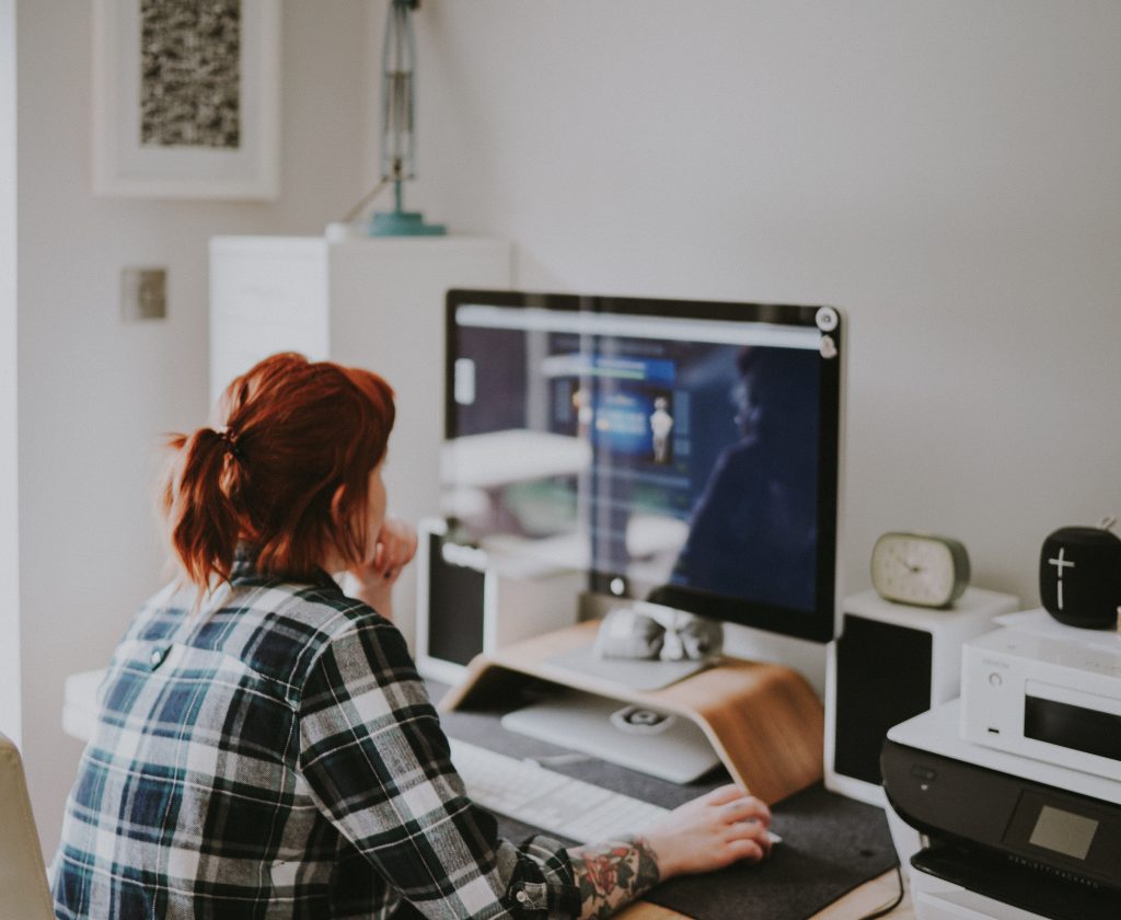 Designer working at an iMac in a bright home office