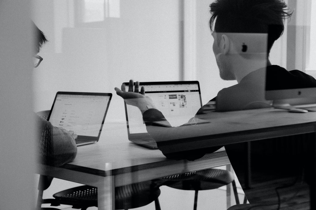 Two people reviewing a local SEO plan at a desk
